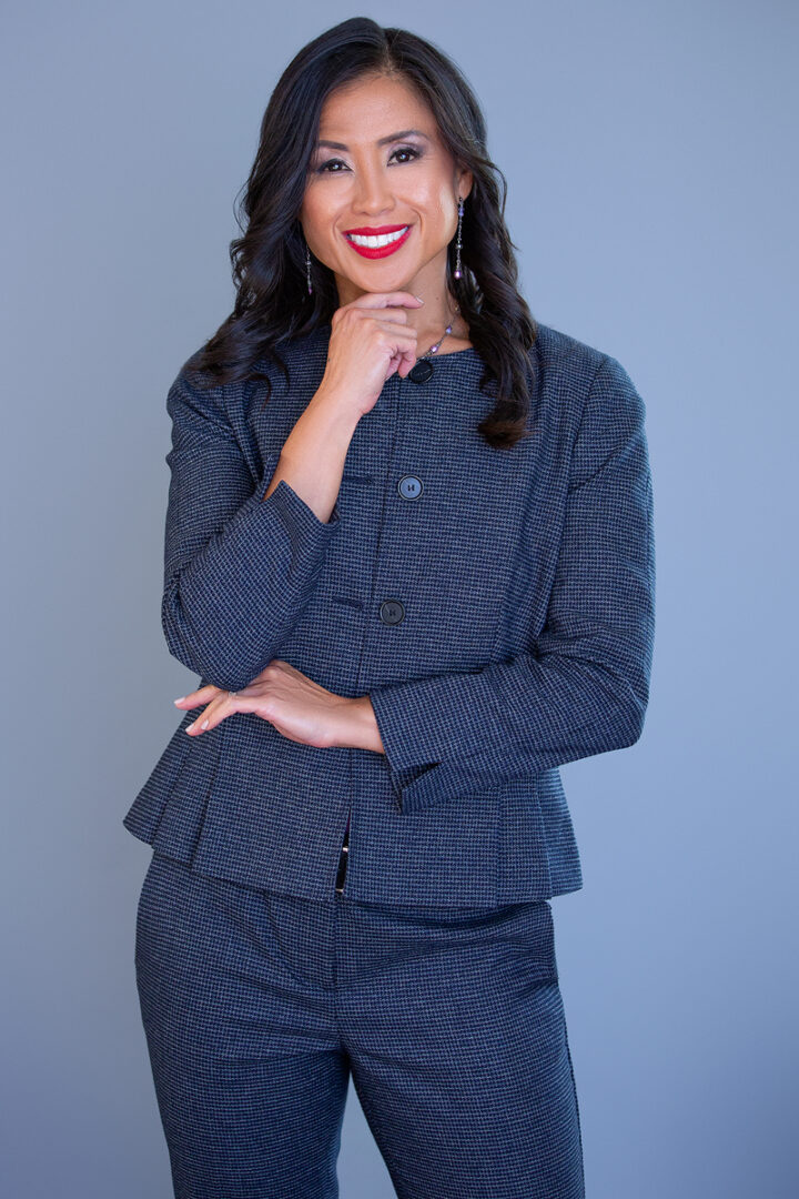 A woman in a suit posing for the camera.