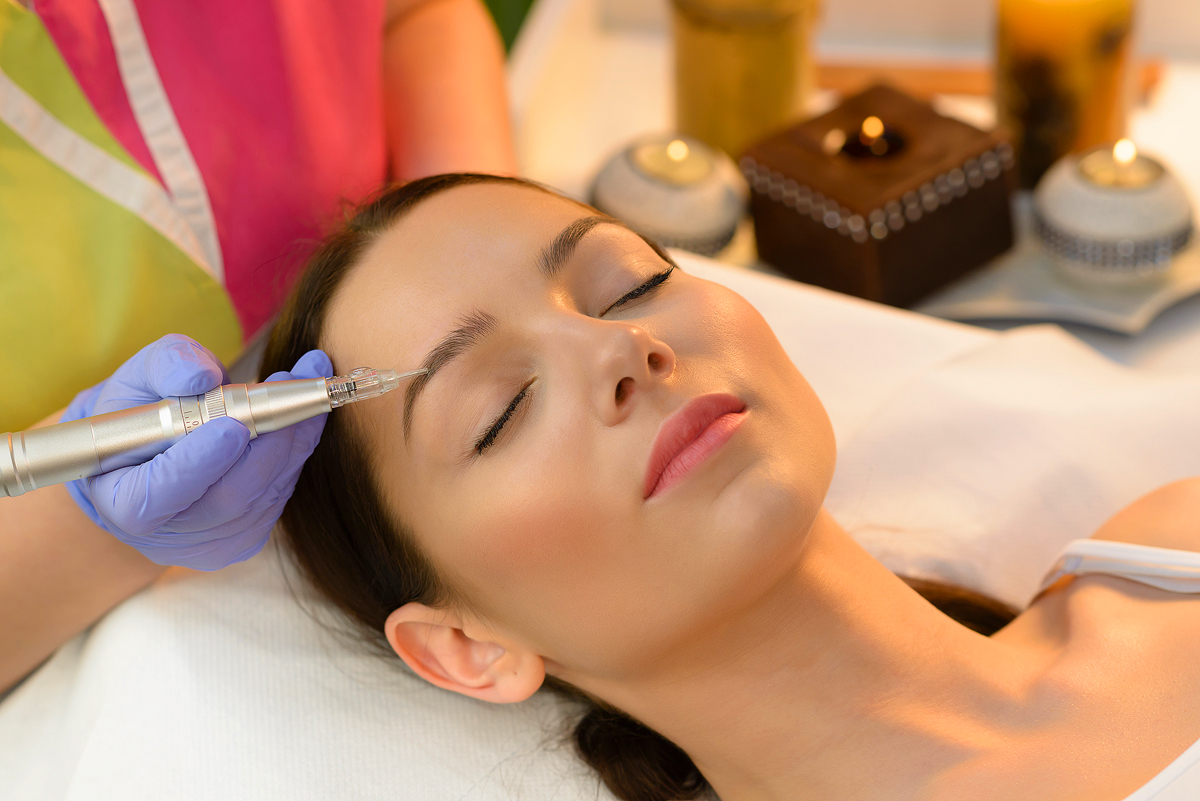 A woman getting her face waxed at the spa