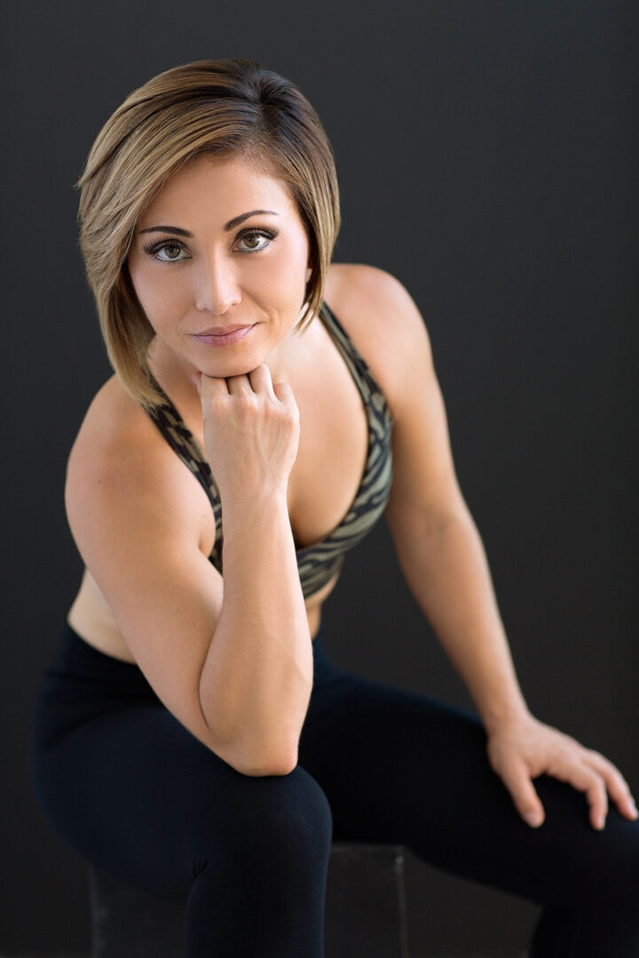 A woman sitting on the ground in black pants