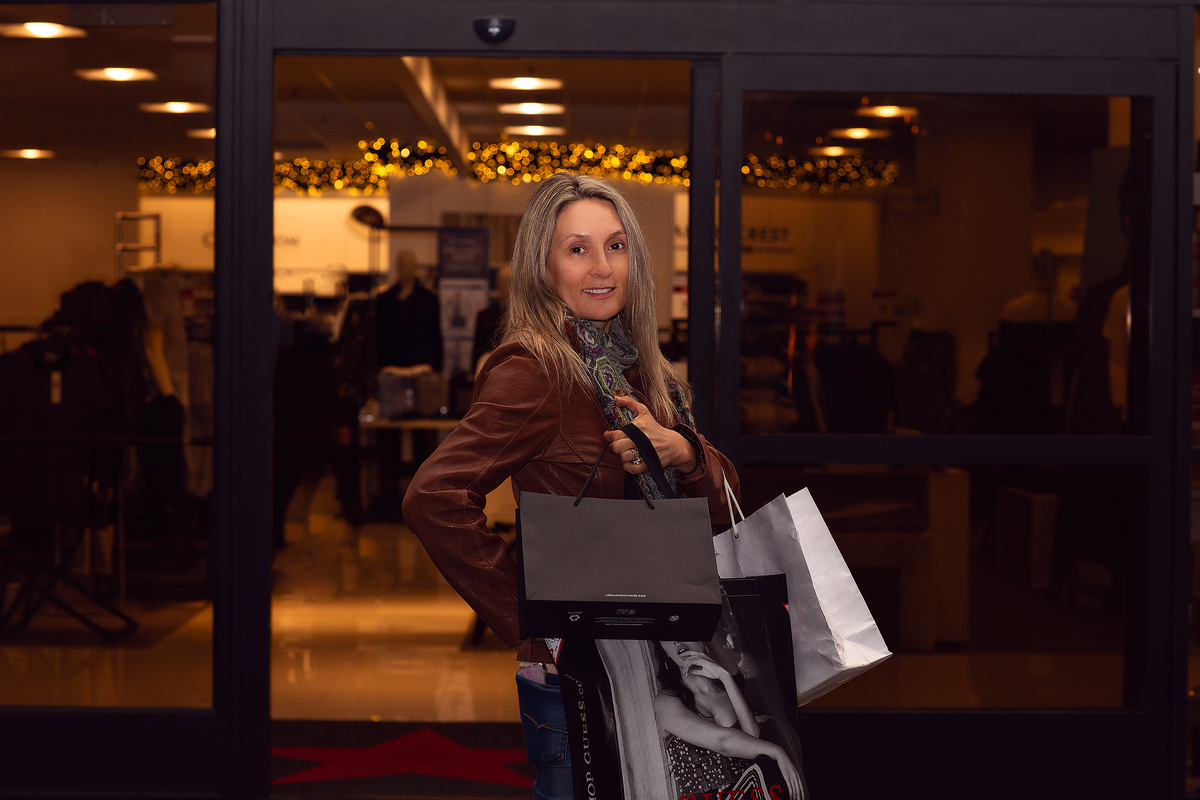 A woman is holding some bags of shopping